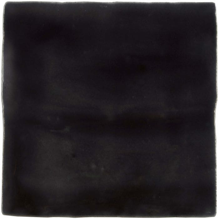 A matte black sloe field tile with rustic uneven edges and subtle surface texture for stylish flooring or walls