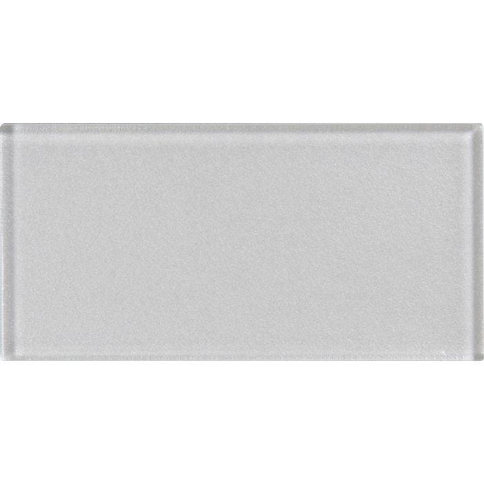 A sleek rectangular glass tile with a subtle matte finish and soft gray hue from solinda metallica brick collection