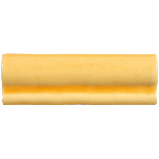 A smooth glossy yellow ceramic straw torus moulding tile with a subtle horizontal deep orange band in the center