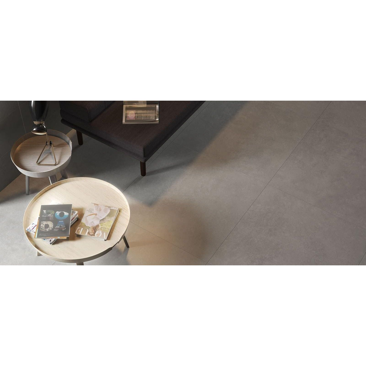 Tanum Ceniza Matt 60 x 60cm grey concrete-effect tiles with a round coffee table