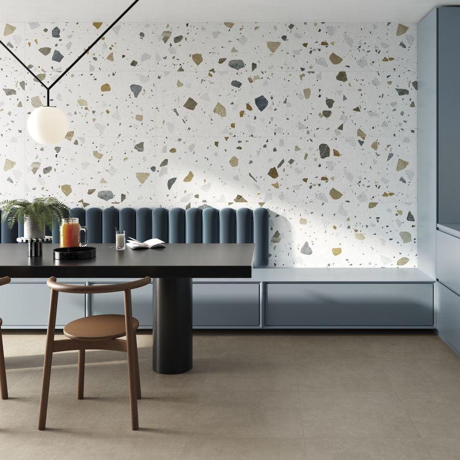 The wall features terrazzo colore light tiles with a modern terrazzo design of gray green and black speckles on white
