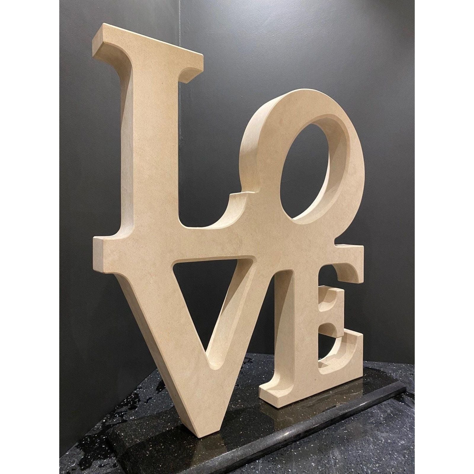 Beige wooden love letter sculpture with clean bold typography and minimalist design for home decor