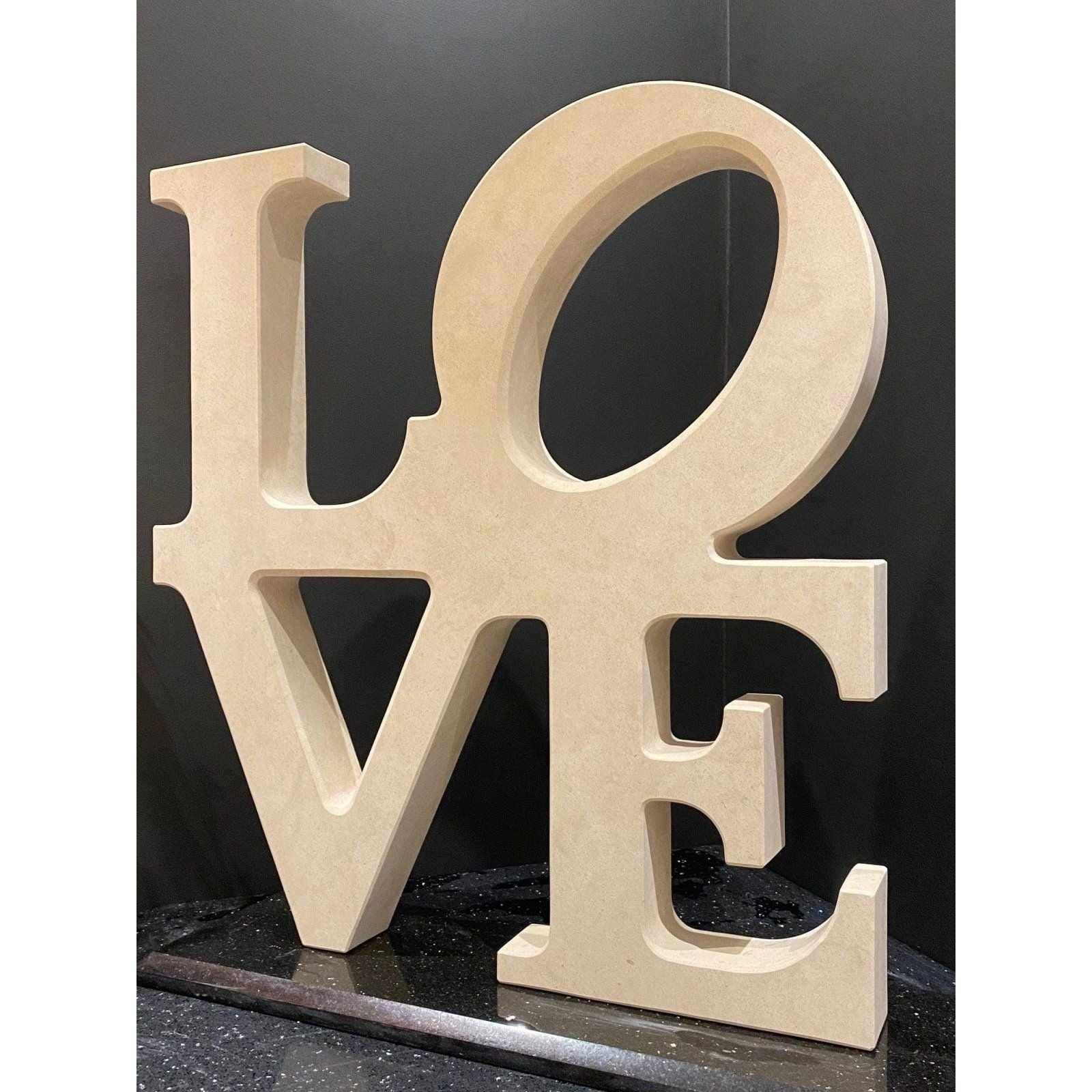 Beige wooden love letter sculpture featuring a smooth finish for decorative home display