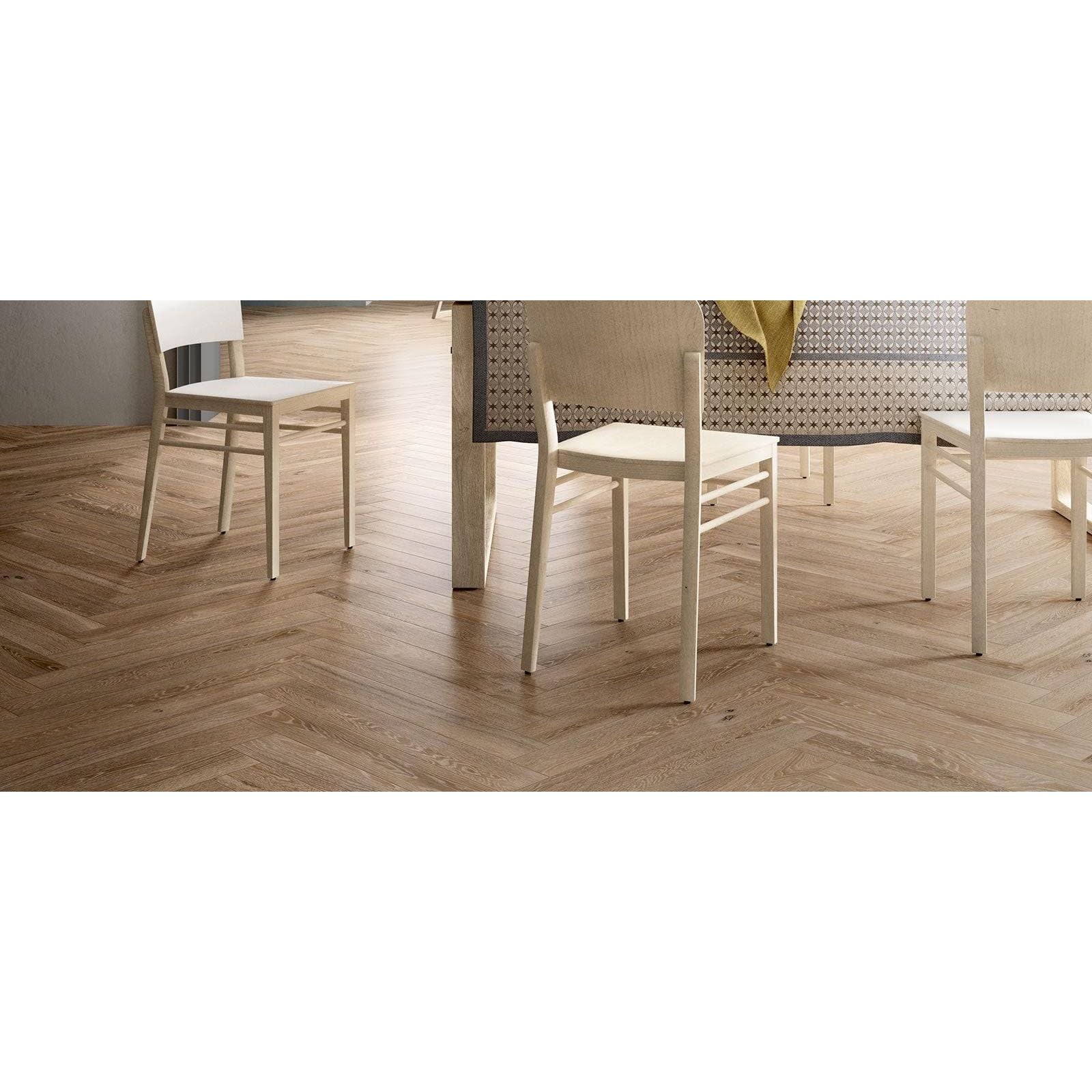Light-colored wooden herringbone floor tiles in beige matt finish tree charme ideal for indoor flooring