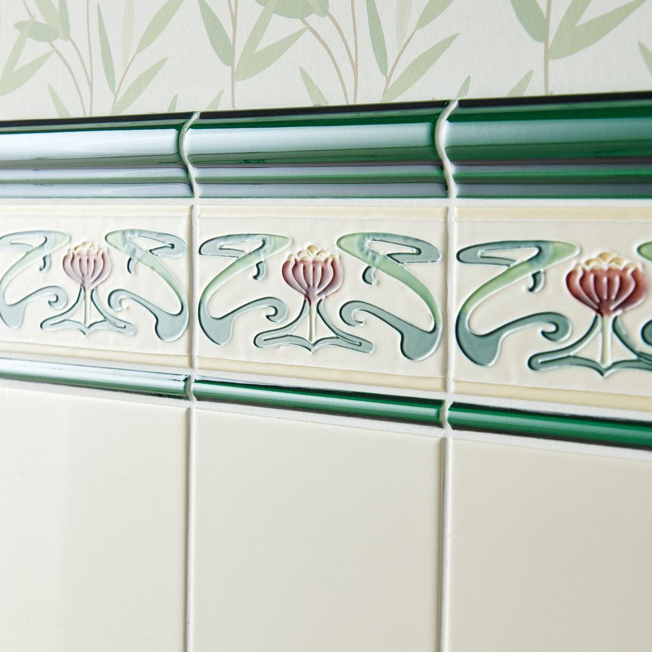 Victorian green omega moulding ceramic tile border with art deco raised floral motifs in pink sage and cream colors