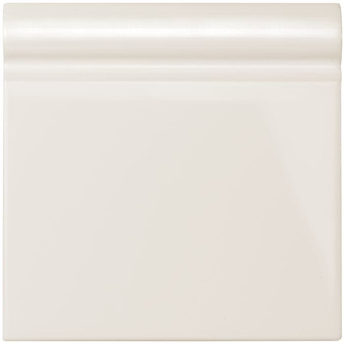 Vintage white skirting tile featuring cream-colored glossy ceramic baseboard trim for elegant wall finishing