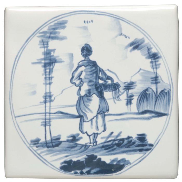 White ceramic tile featuring a blue and white delft-style illustration of a woman walking with a basket in a landscape