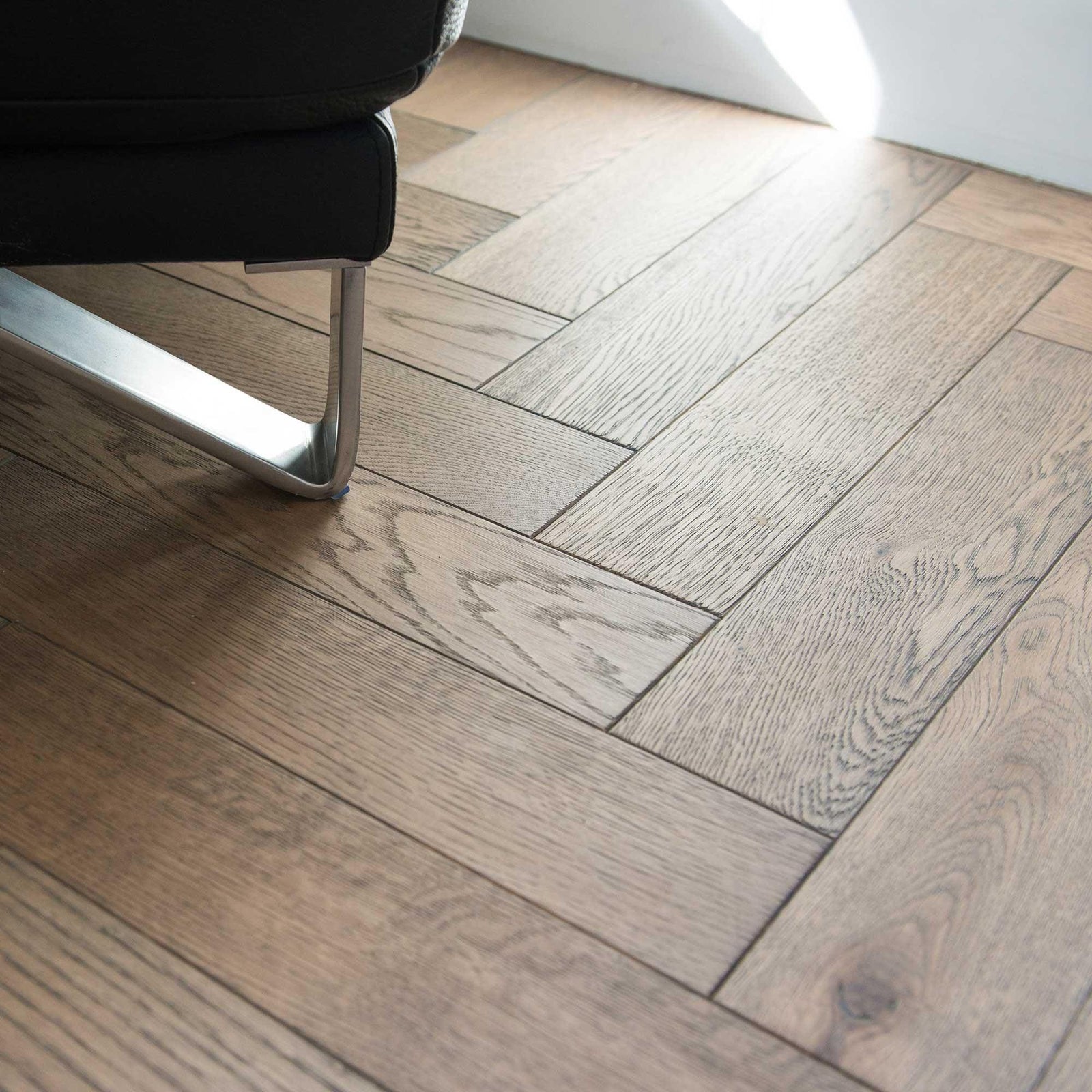Light gray wood floor in herringbone pattern from ZB101 Frozen Umber collection