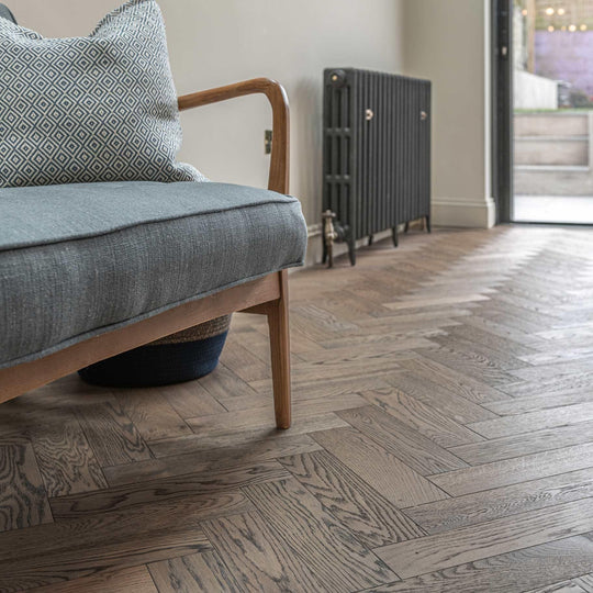 Gray herringbone-patterned hardwood floor in zb101 frozen umber featuring durable wood material and modern design