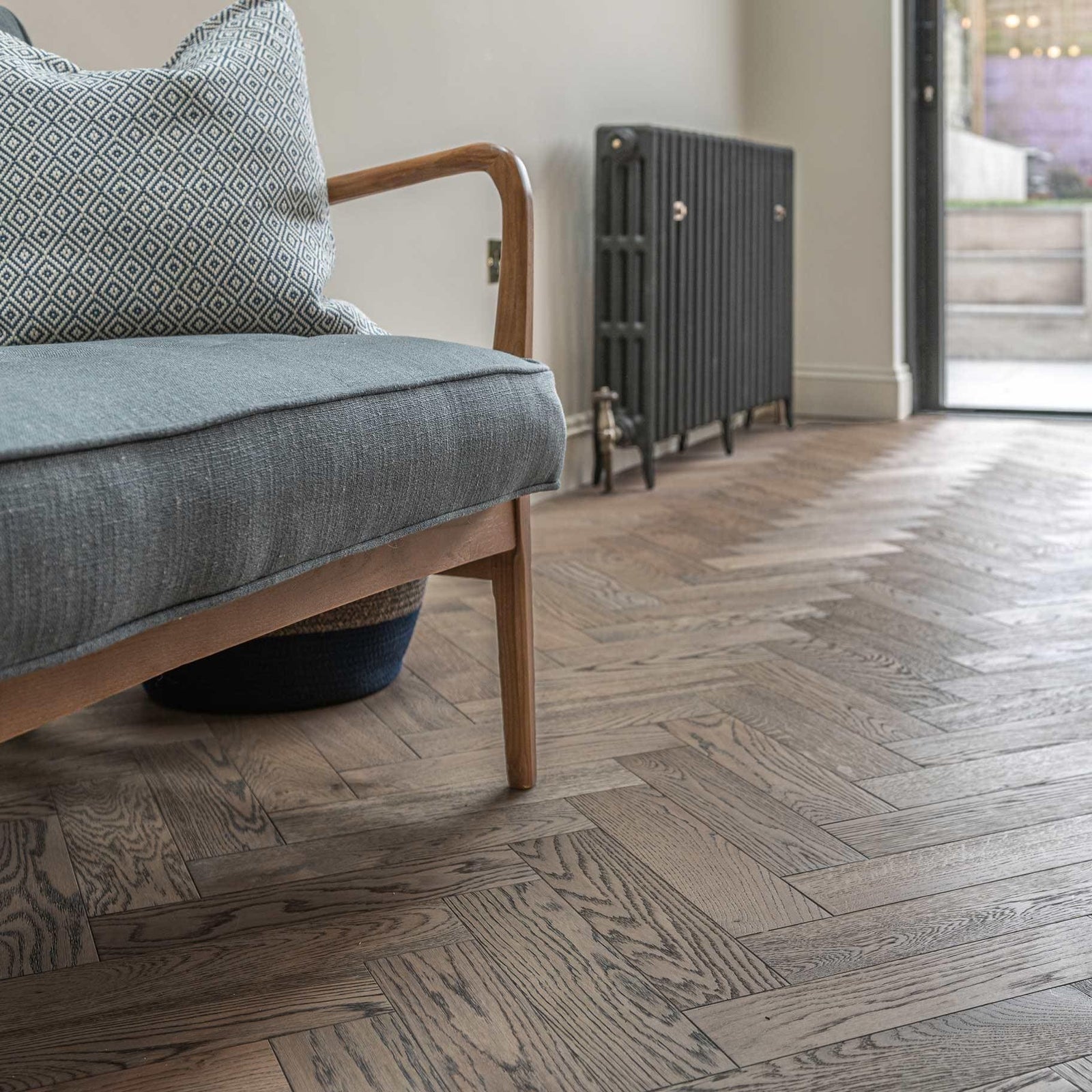 Gray herringbone-patterned hardwood floor in zb101 frozen umber featuring durable wood material and modern design