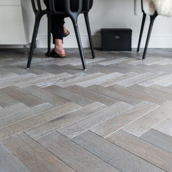 Gray herringbone-patterned silver haze hardwood floor planks showcasing color texture and material details