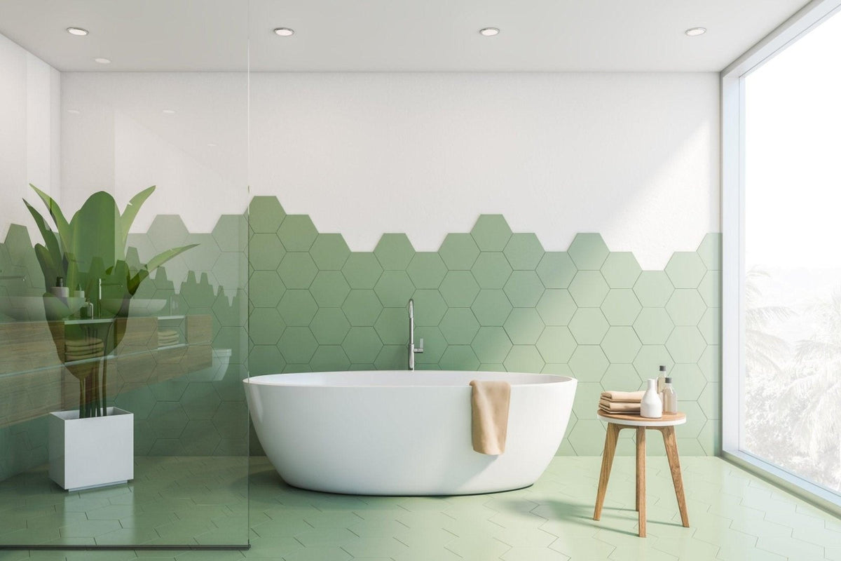 White freestanding bathtub with sleek modern design and smooth surface in a porcelain tile home setting.