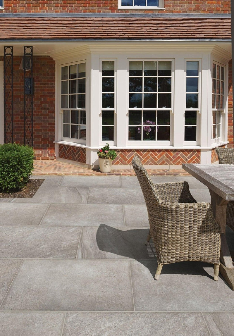 Woven wicker patio chair with light beige finish and natural texture for garden tiles outdoor space ideas