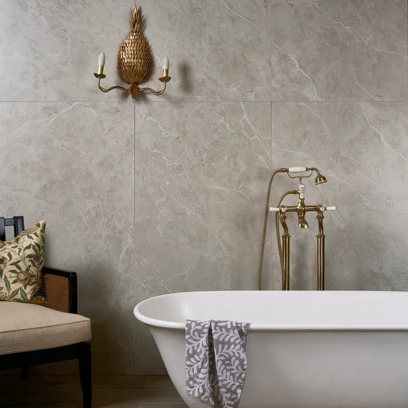 Grey marble-effect porcelain floor and wall tiles in a bathroom with a freestanding bath — Holland Park porcelain from Hyperion Tiles