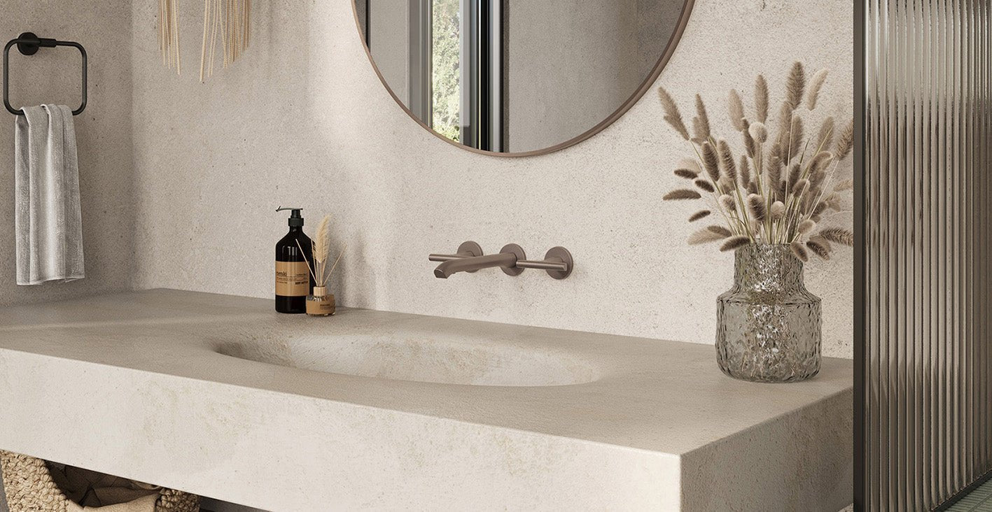 A textured metallic silver vase with faceted design holding dried pampas grass to elevate your bathroom accessories