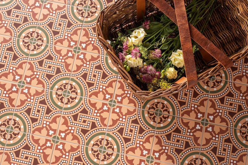 Woven wicker basket with brown leather straps filled with cream and purple flowers for elegant victorian tiled floors decor