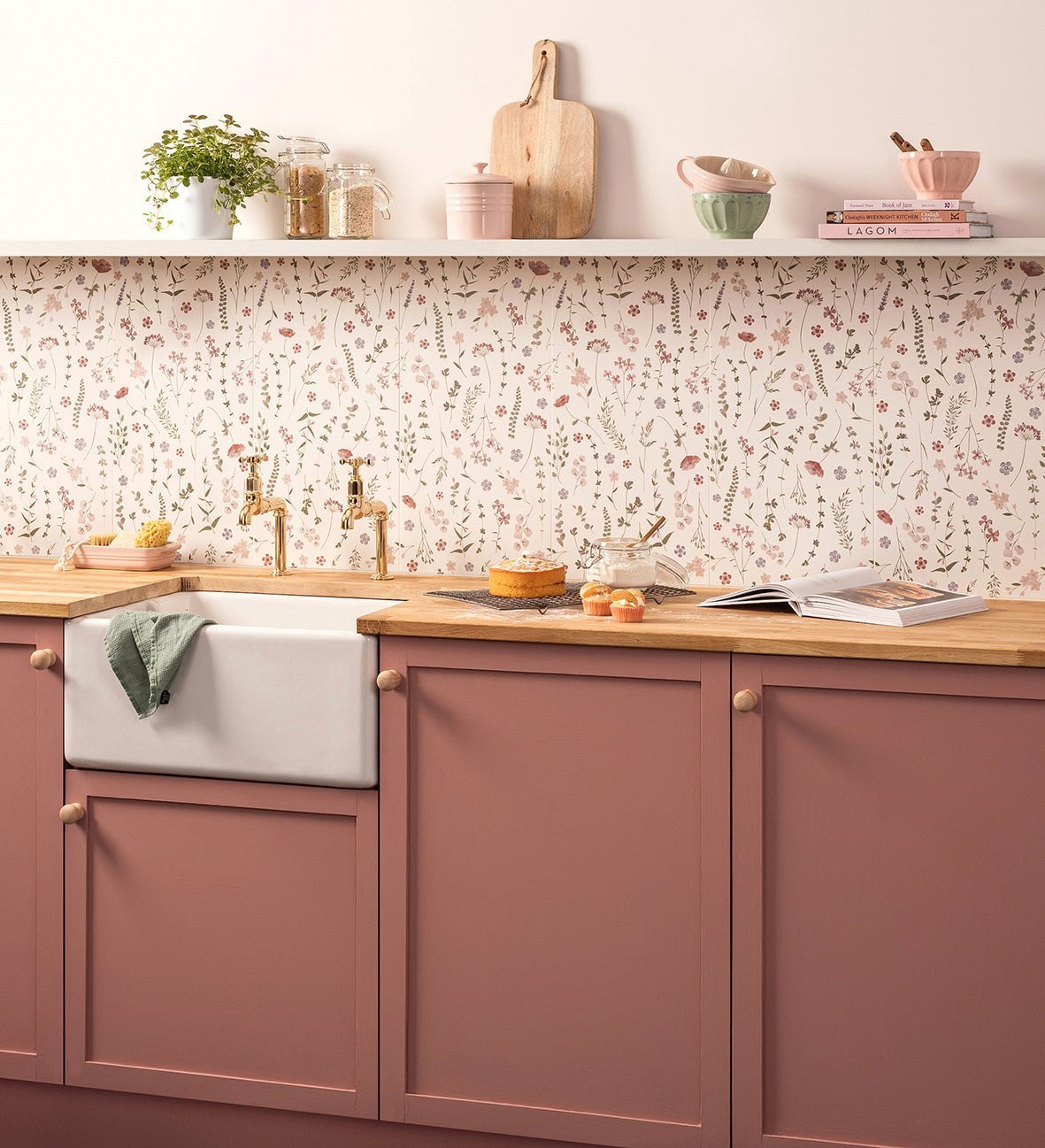 Pink kitchen cabinets with wooden knobs and white farmhouse sink complement patterned tiles in home renovation guide