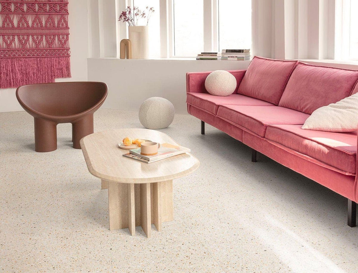 Pink velvet sofa with matching cushions and black legs on lvt flooring illustrating style and comfort benefits