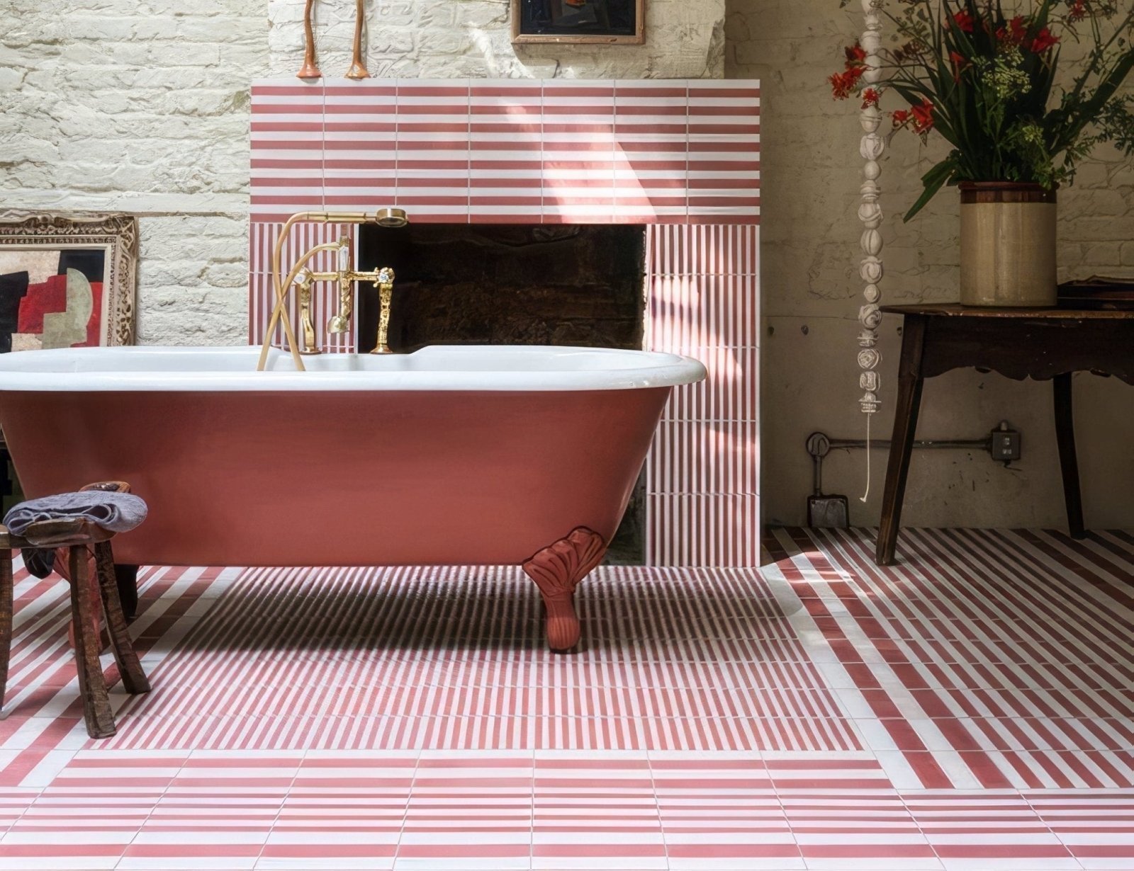 A vintage freestanding bathtub with a matte rose pink finish and ornate claw foot legs for bathroom decor
