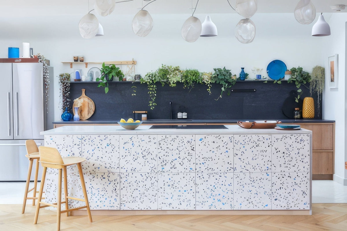 White terrazzo kitchen island with speckled blue and gray accents for stylish durable home use