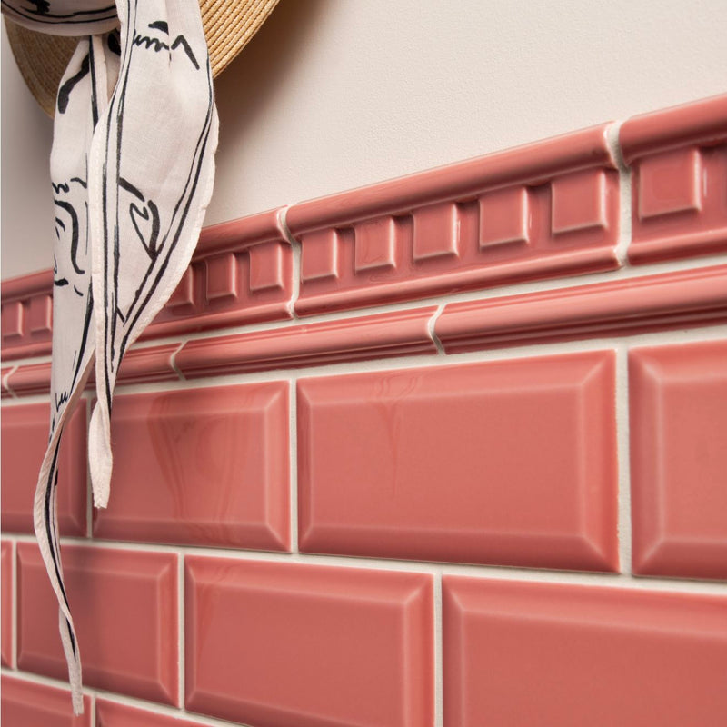 Pink glossy rectangular ceramic tiles with raised edges arranged in a brick pattern from artworks astragal moulding