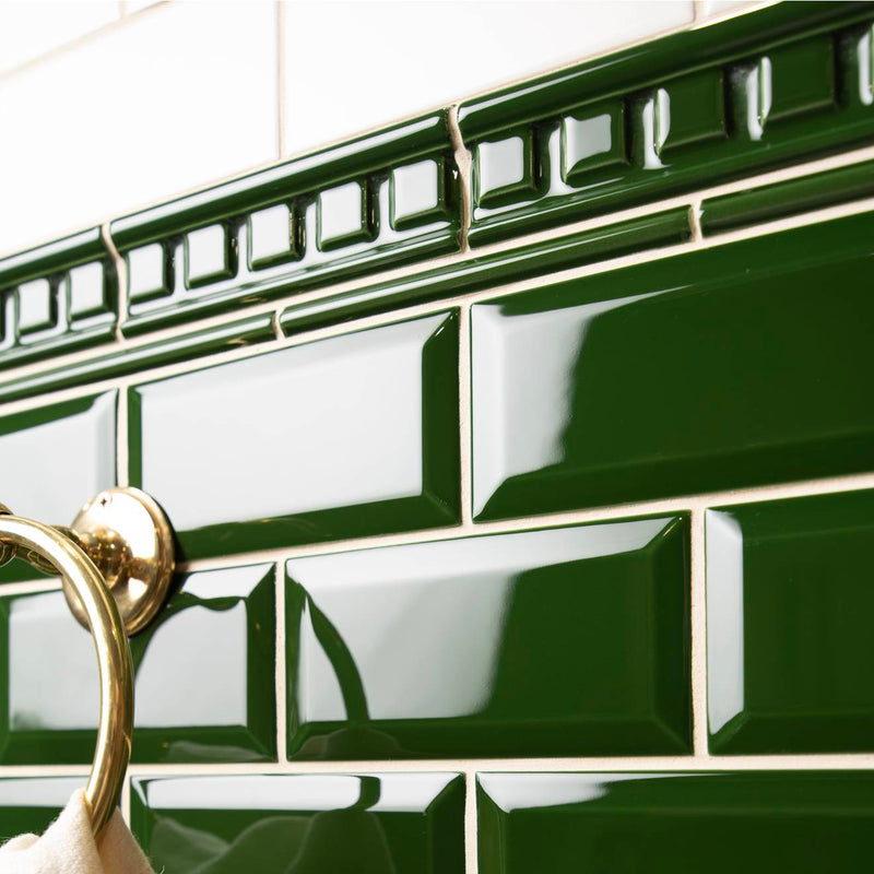 Deep green glossy ceramic subway tiles with raised rectangular border design from artworks dentil moulding collection