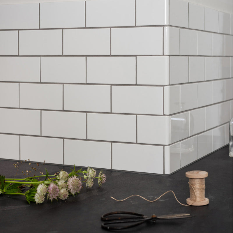 White subway tile half tile external wrapping piece with gray grout for modern kitchen backsplash design