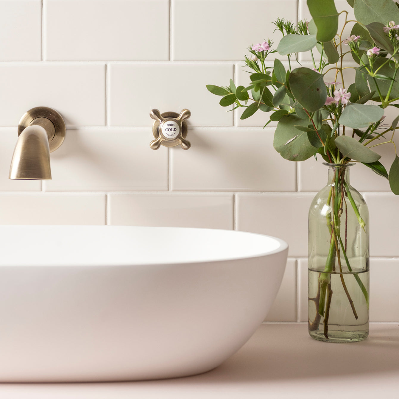 White ceramic vessel sink with brushed brass faucet and cold water knob from artworks half tiles collection