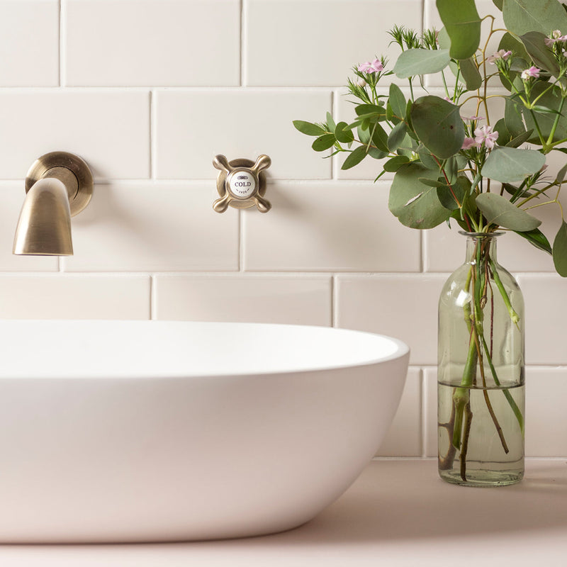 White ceramic vessel sink with brushed brass faucet and cold water knob from artworks half tiles collection