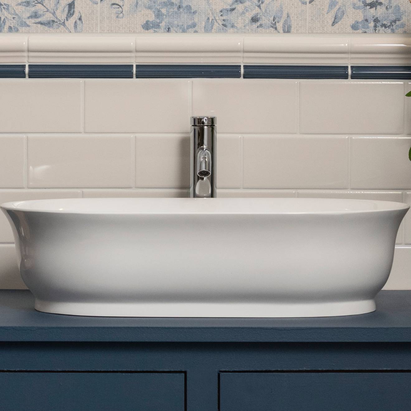 White oval ceramic bathroom sink with sleek modern design and polished chrome faucet from artworks omega moulding collection