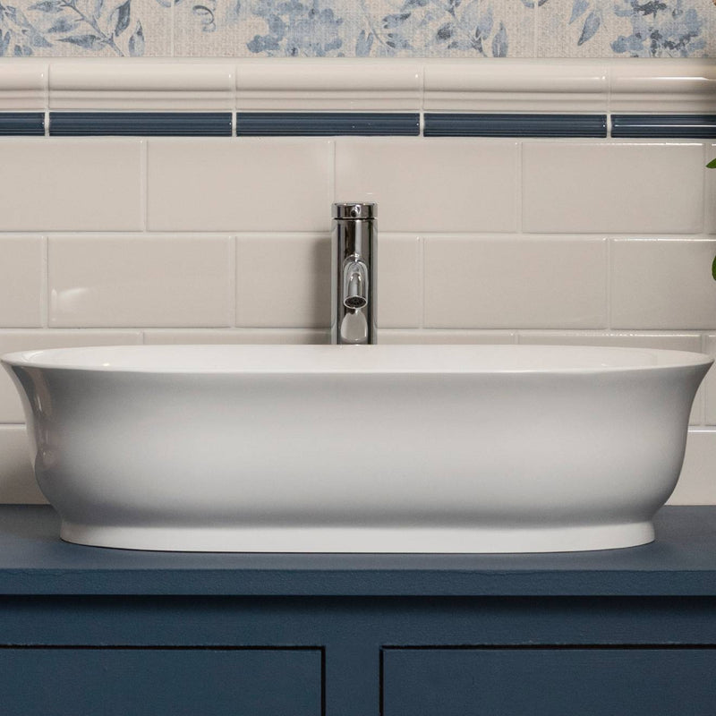 White oval ceramic bathroom sink with sleek modern design and polished chrome faucet from artworks omega moulding collection
