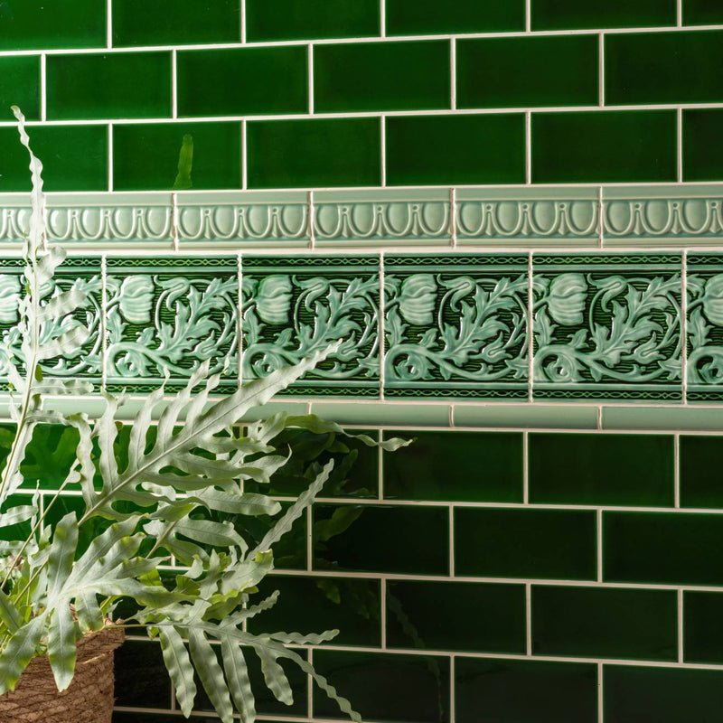 Deep green ceramic subway tiles with embossed floral and foliate patterns from berkeley decorative tile jade breeze on victorian green