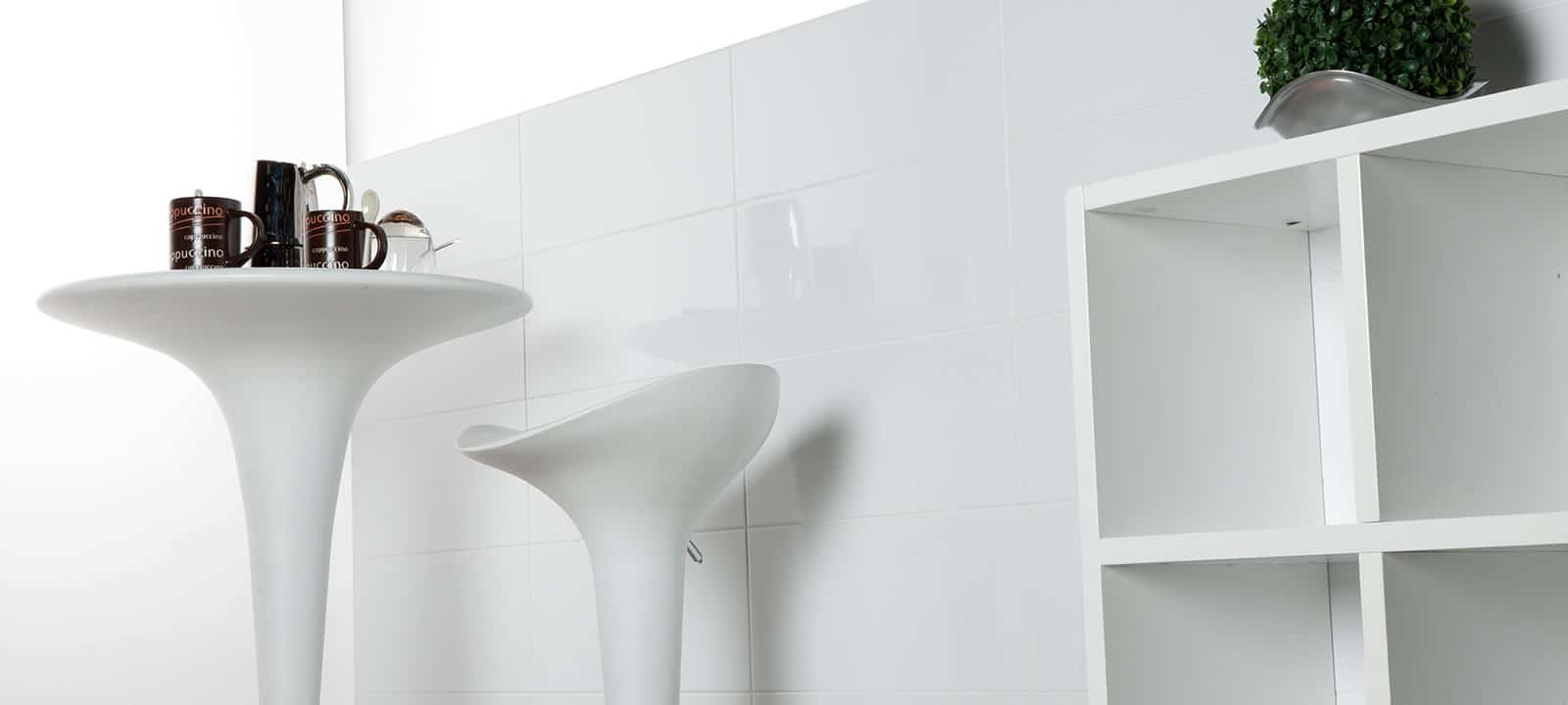 White pedestal table with sleek modern design and smooth surface from the blancos collection