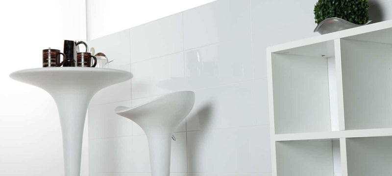 White pedestal table with sleek modern design and smooth surface from the blancos collection