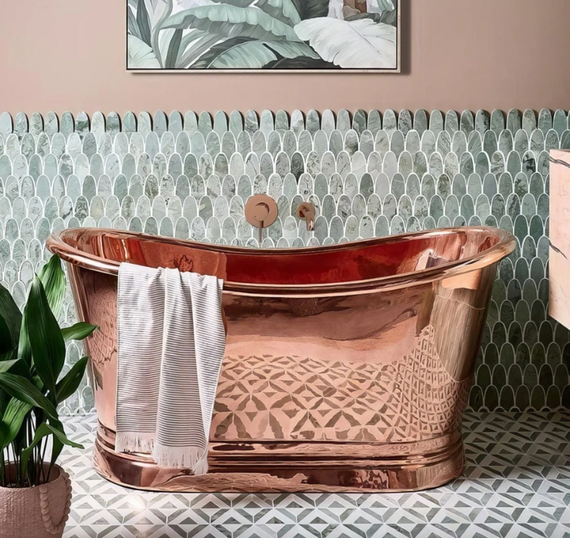 A polished copper bathtub with geometric etched patterns and rounded edges from the East Java Marble collection.