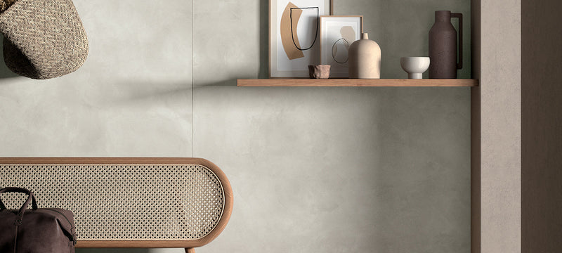 A woven wicker hat with a natural textured surface and oval shape hanging on the wall in the clay collection