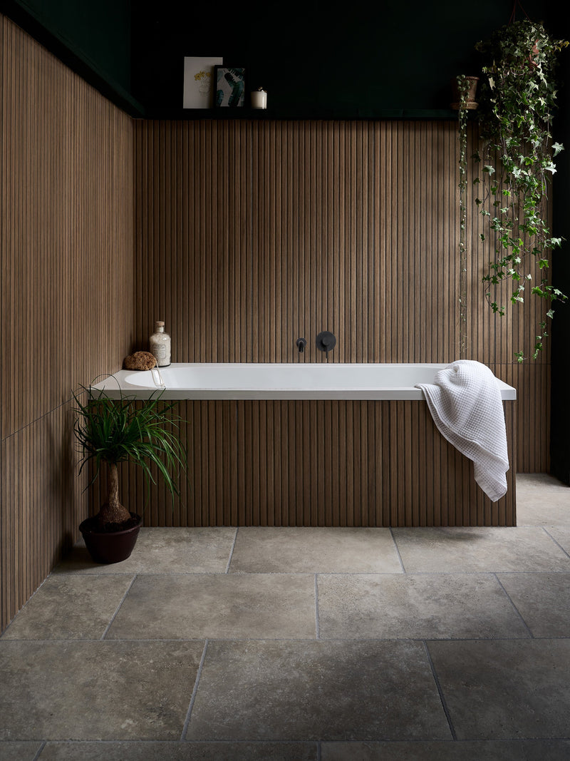 White rectangular porcelain bathtub with sleek modern design set against vertical wood paneling from kinfolk porcelain collection