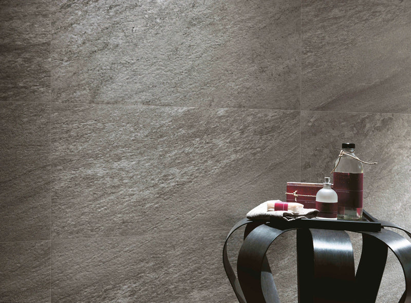 Gray stone-effect wall tiles with a textured natural surface from the bravestone collection for interior walls