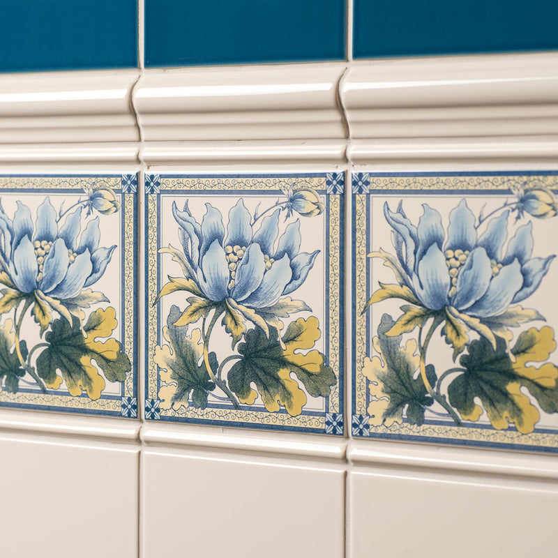 Blue and yellow floral ceramic peony decorative tile with intricate detailing on county white background