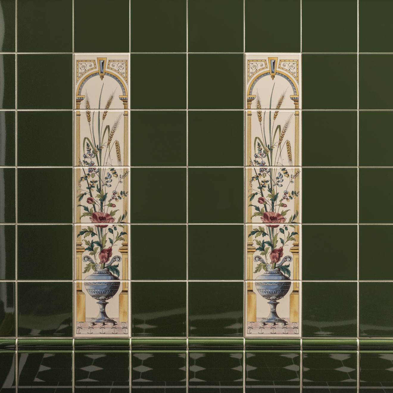 Two tall ceramic tiles with ornate gold arches and botanical illustrations in poppies floral decorative tile red on county white collection
