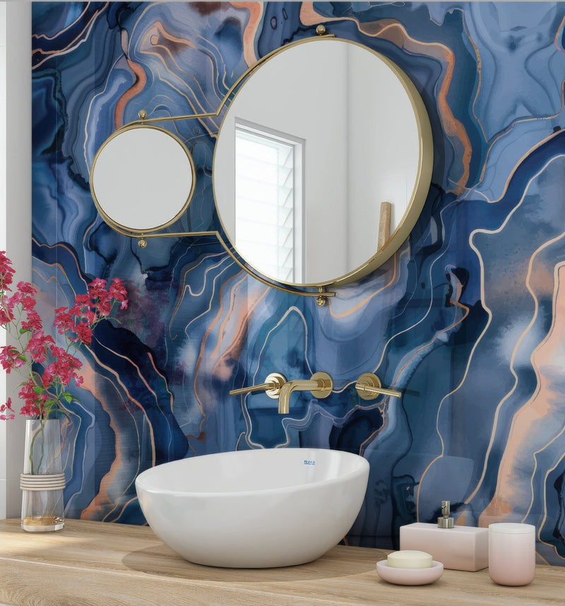 White ceramic vessel sink with gold-toned faucet and wall-mounted mirrors against blue and copper marbled abstract wall panels