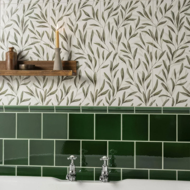 Emerald green glossy subway tiles with white grout form a sleek modern backsplash in arts and crafts style