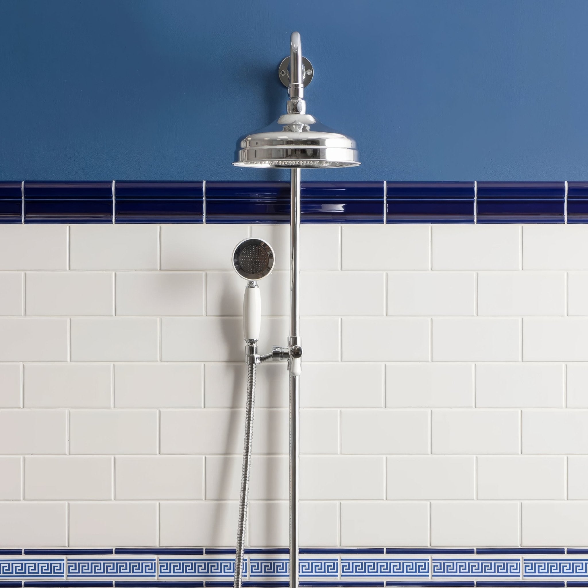 Chrome finished showerhead with sleek rounded design and matching handheld nozzle from artworks brilliant white collection