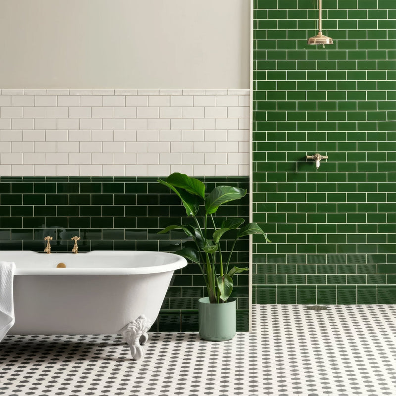White clawfoot bathtub with gold fixtures from the artworks edwardian green collection for elegant bathroom decor