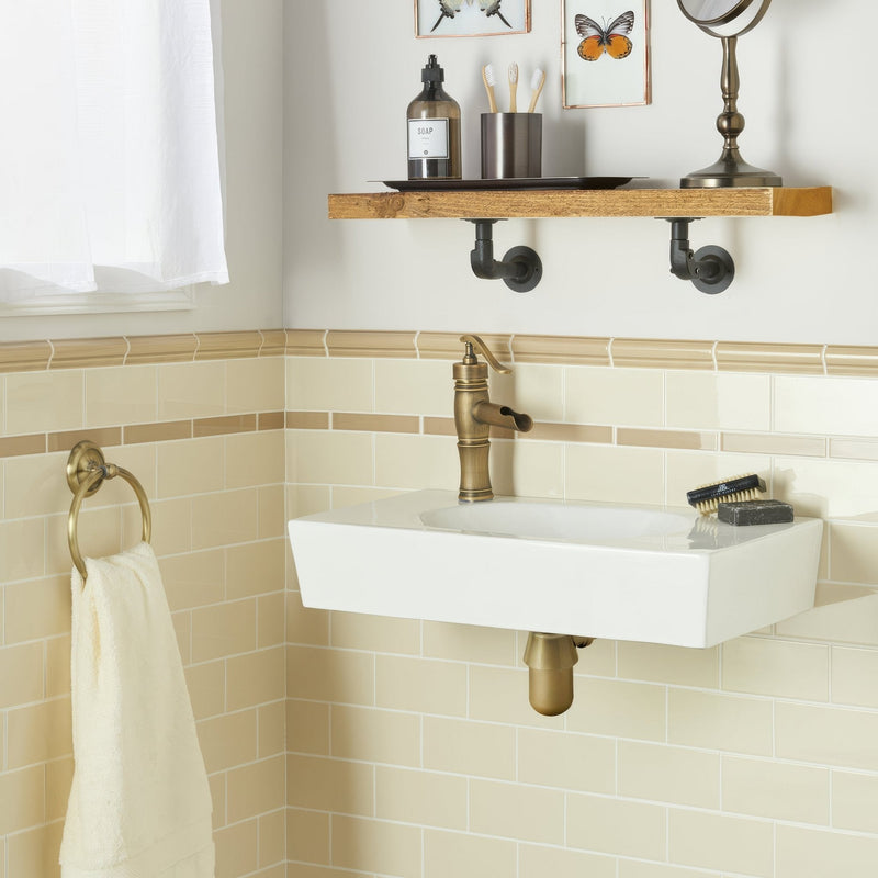 White rectangular wall-mounted porcelain sink with brass faucet from artworks ivory collection for bathroom use