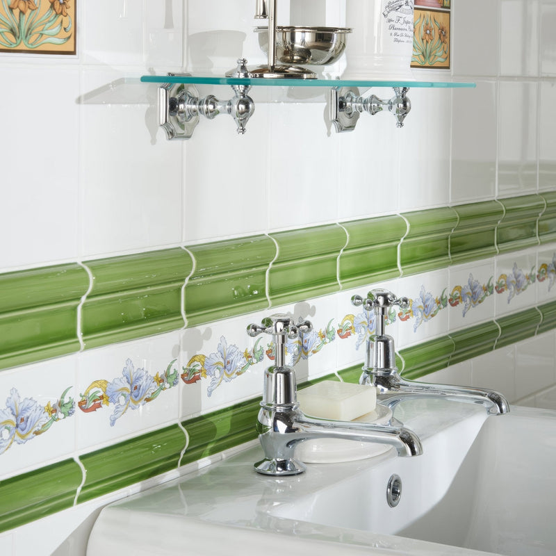 Chrome finished cross-handle faucets with polished metal spouts on a white ceramic sink from artworks pavilion green collection