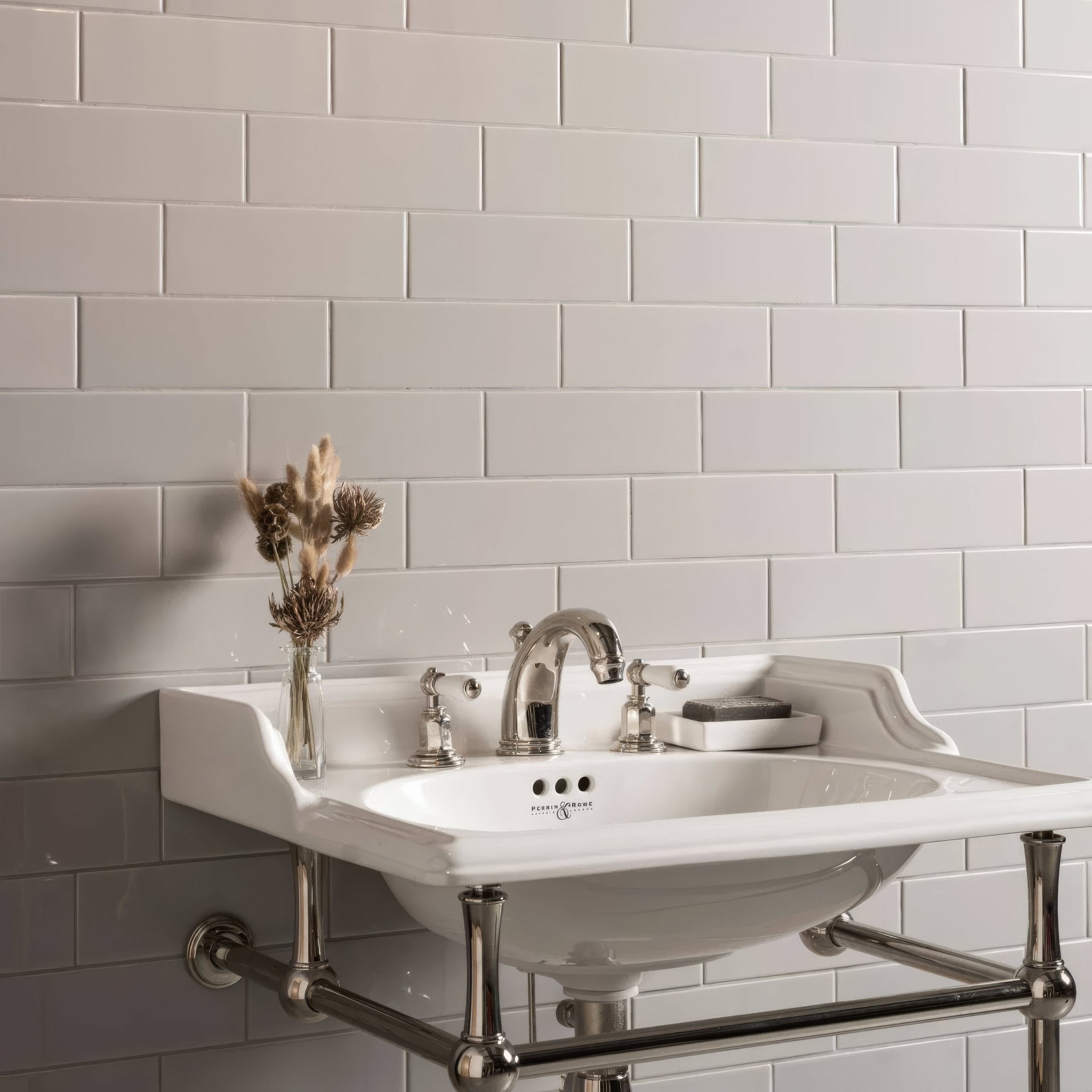 White ceramic sink with chrome fixtures and matching towel rack from Artworks Westminster Grey Collection.
