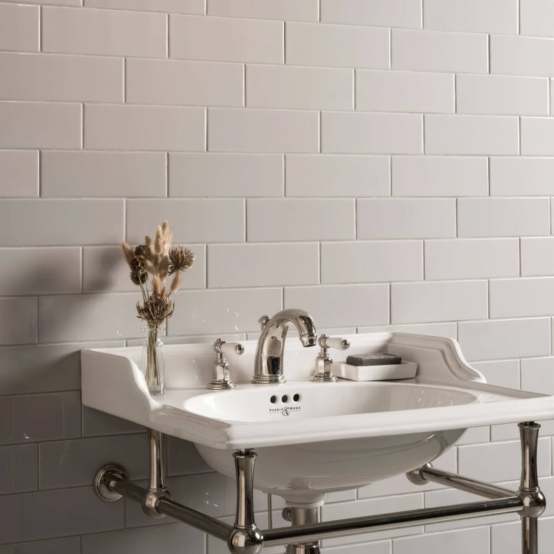White ceramic sink with chrome fixtures and matching towel rack from Artworks Westminster Grey Collection.