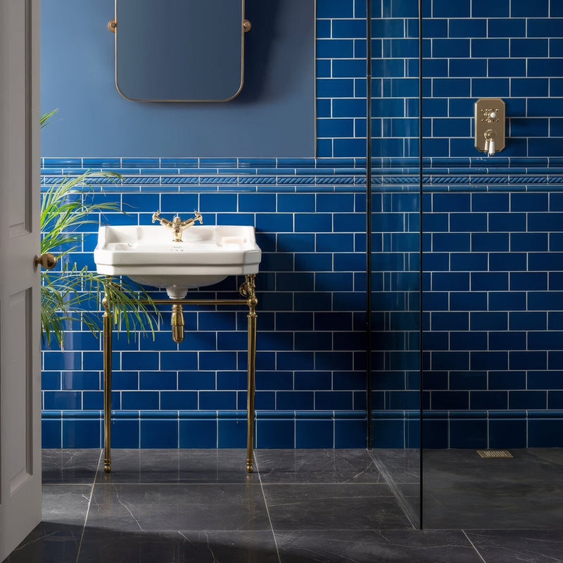 White ceramic pedestal sink with ornate gold finished metal legs and faucet from artworks windsor blue collection