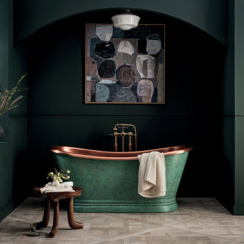 A verdigris-finished copper bathtub with polished brass faucet and towel in the bathroom paint collection.